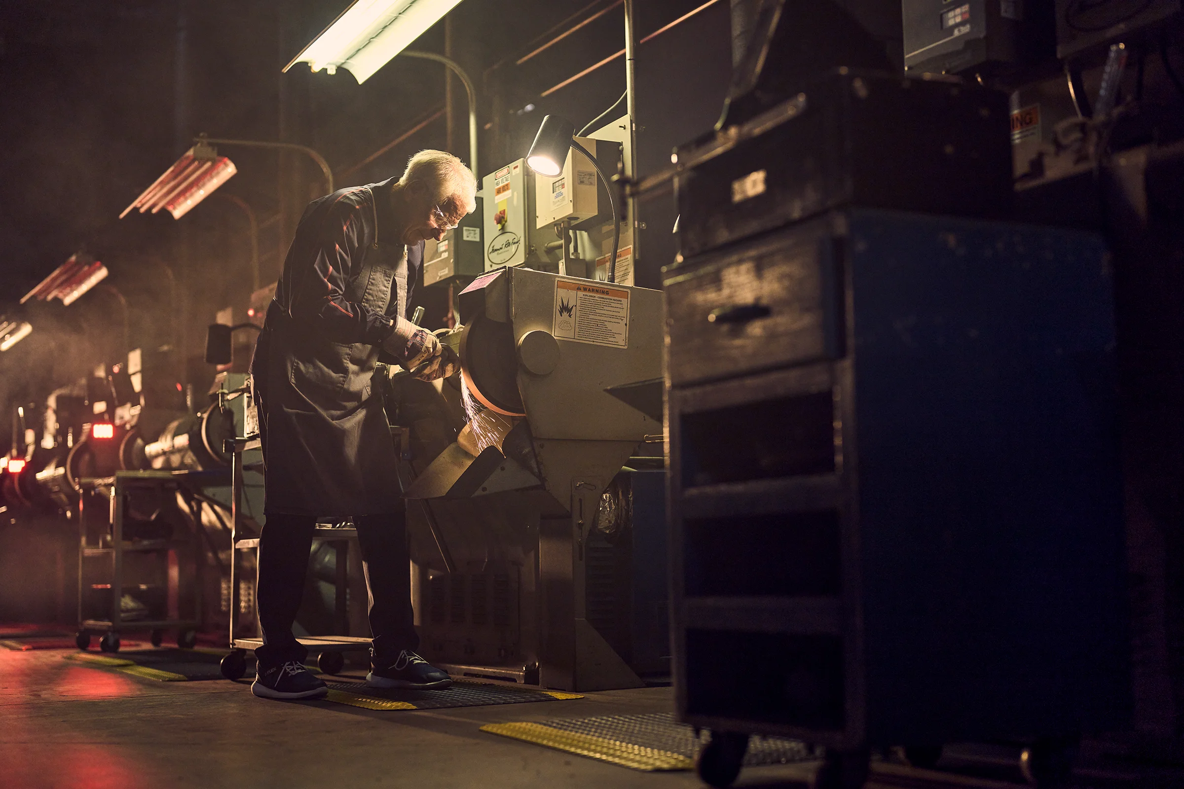 Bob Vokey grinding golf wedges in his workshop.