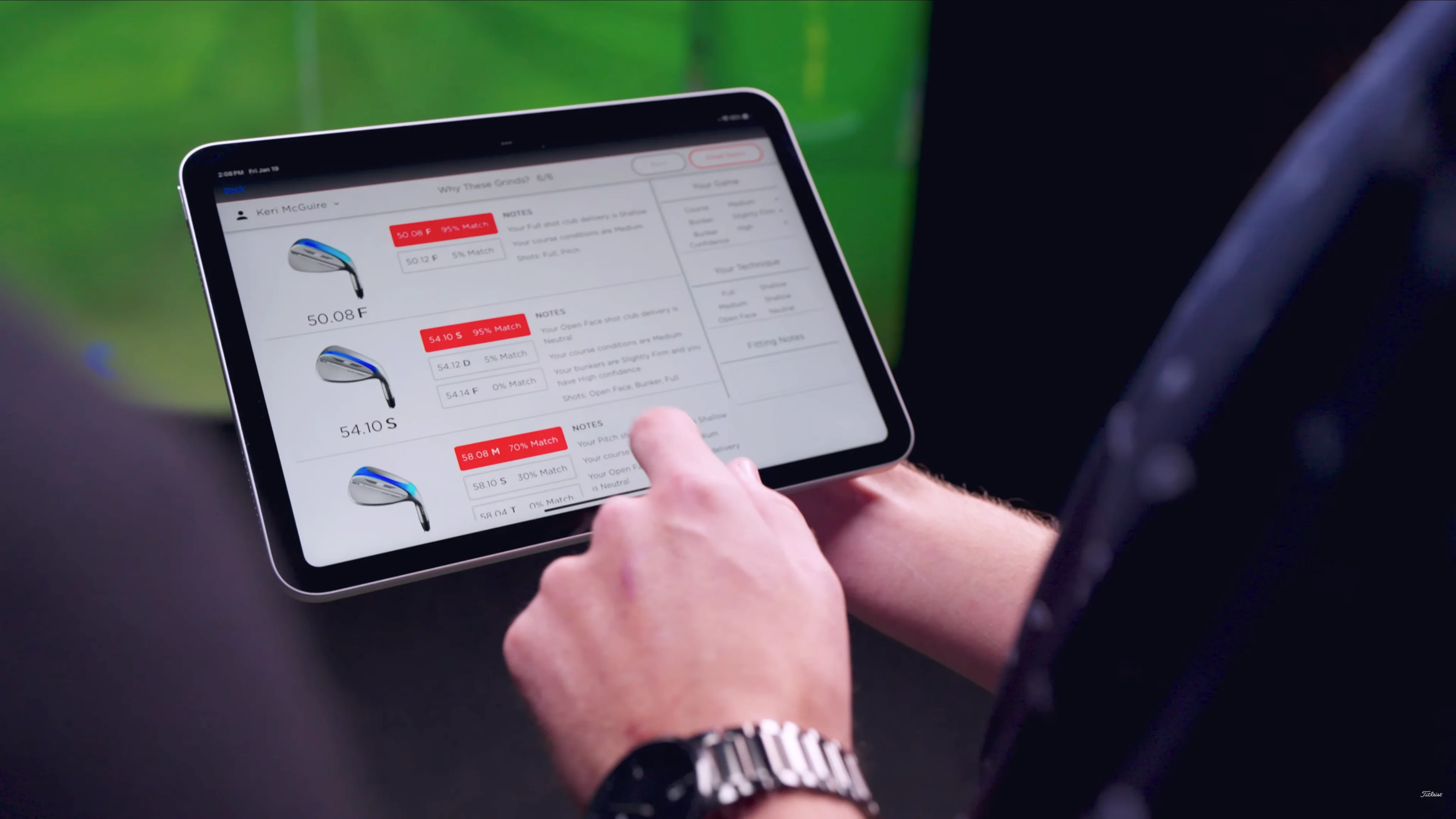 A person holding a tablet with grind specifications shown in the wedge fitting app.